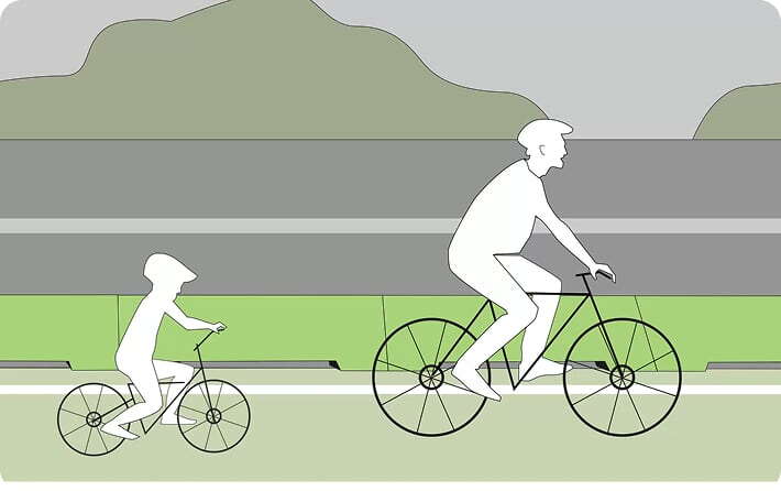 Illustration of an adult and a child riding bicycles on a path. The adult is on a larger bike while the child rides a smaller one, with hills and a road barrier in the background.